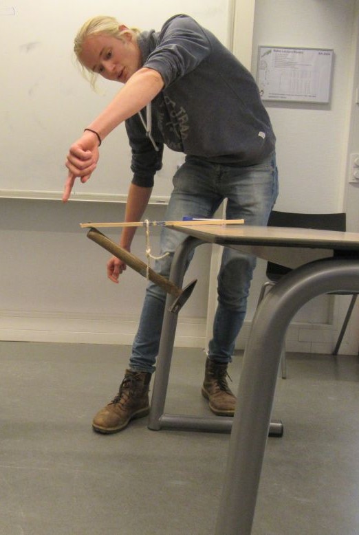 David balances a hammer, the center of mass should be under the table, not next to it.