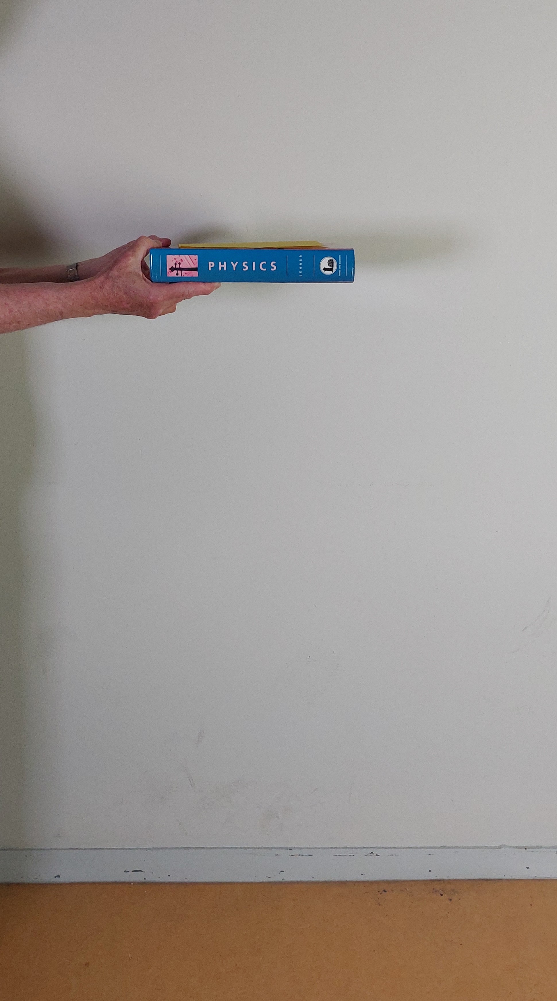 What will happen if you drop a book with a sheet of paper on top of it?