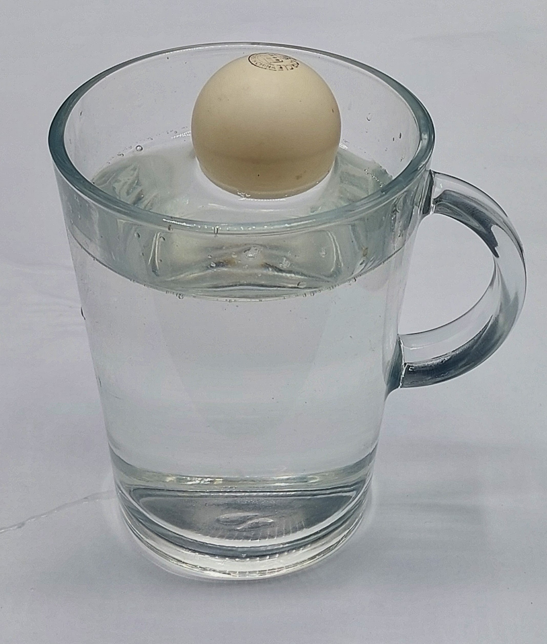 Meniscus below the rim (concave, hollow).