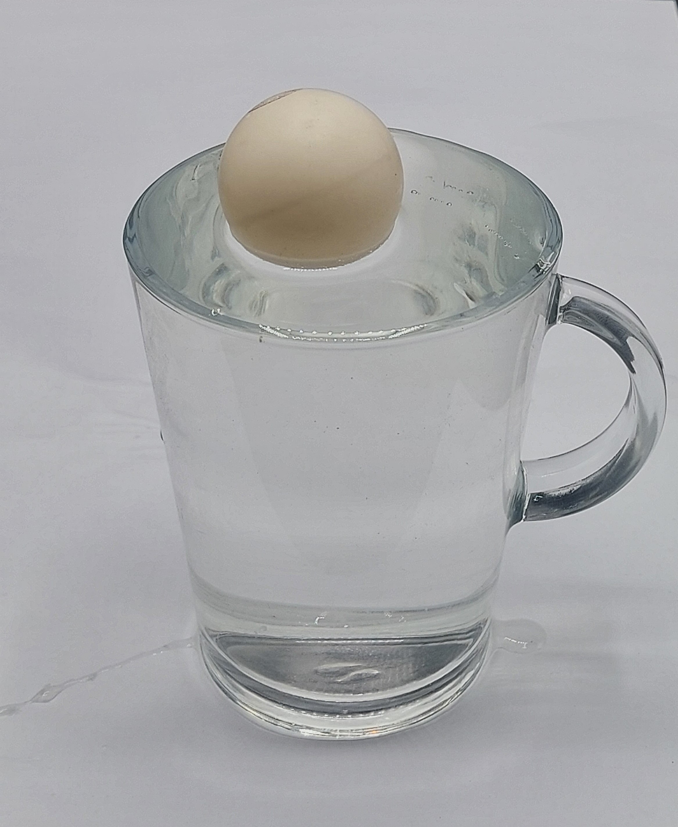 Meniscus above the rim (convex).